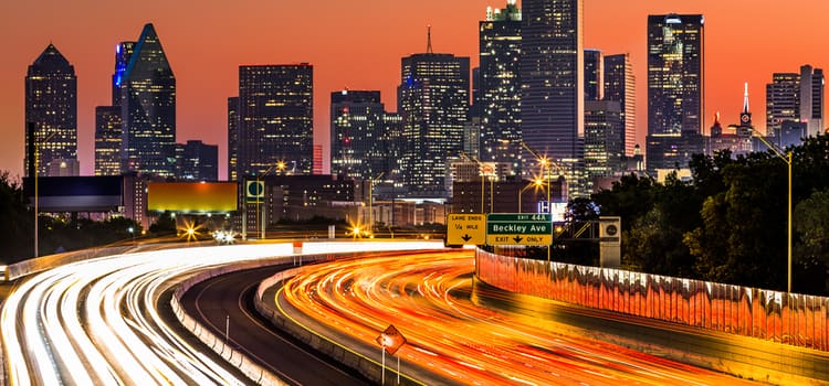 a long exposure of a dallas highway after sunset