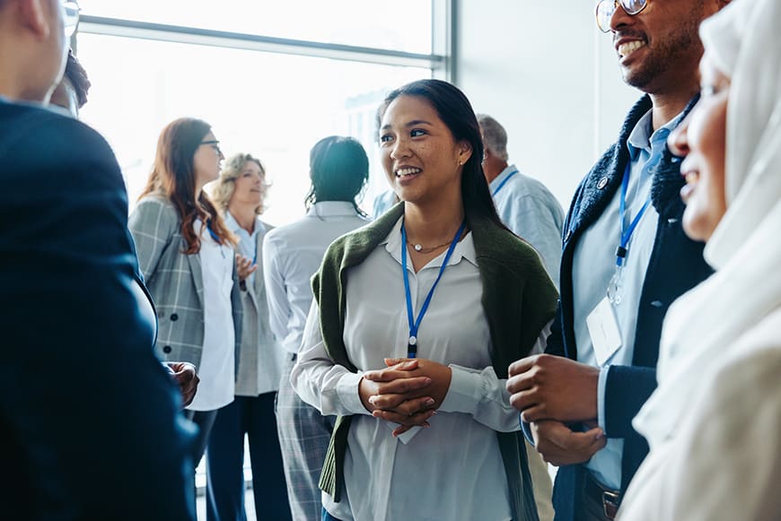 Conference attendees network at an event