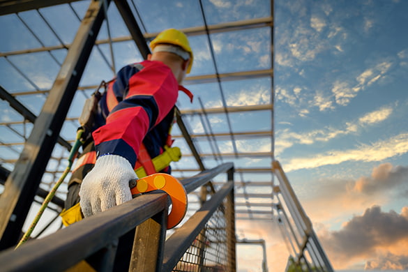 A construction worker traverses a job site