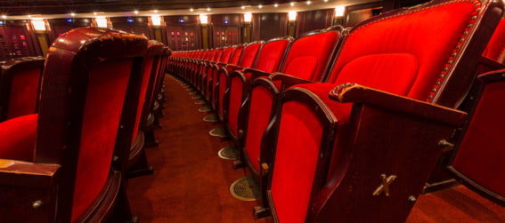 inside of a theater with close up on red seats